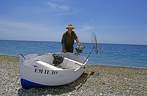 Fisherman and boat on beach, Almunecar, Andalusia, Spain, Europe