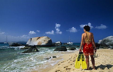 Woman with snorkelling equipment on the beach, The Baths on Virgin Gorda island, British Virgin Islands, Caribbean