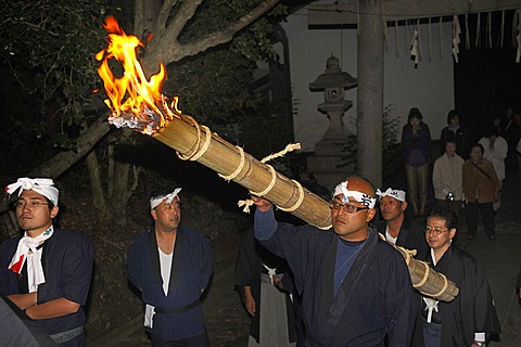 For a fire-Matsuri in Autumn torches are lit in each district and carried through the streets to the Shinto shrine, Iwakura in Kyoto, Japan, Asia