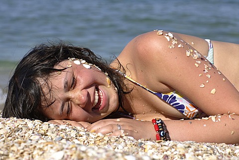 Girl, 12 years old, lying on the beach