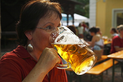 Woman drinking a litre of beer, Beer Garden at the Flaucher, Thalkirchen, Munich, Bavaria, Germany, Europe