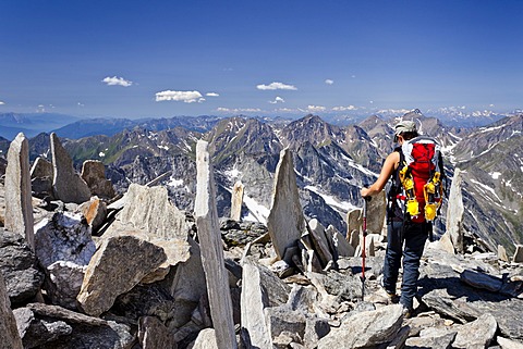 Mountaineer descending from Hochfeiler mountain, Pfitschertal valley, Pfitschertal valley and Wipptal valley at the back, province of Bolzano-Bozen, Italy, Europe