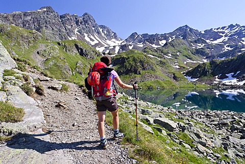 Mountaineer at GroâˆšÃ¼er Schwarzsee Lake, Mt Schwarzwandscharte at back, South Tyrol, Trentino-Alto Adige, Italy