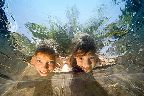 Children are diving in a swimming-pool