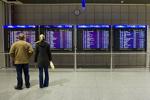 Passengers in front of flight info display screens, Terminal 2, Frankfurt Airport, Frankfurt, Hesse, Germany, Europe