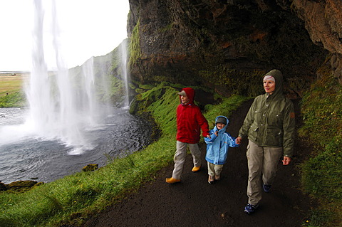 Woman and two children at Seljalandsfoss, Iceland, Europe