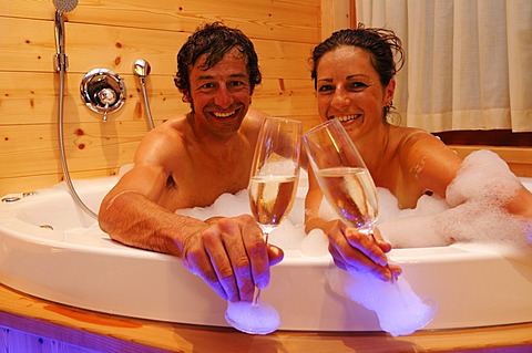 Couple in a jacuzzi, Post Alpina hotel, Alta Pusteria, South Tyrol, Dolomites, Italy,