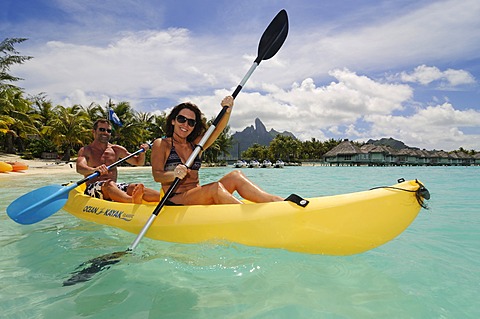 Tourist couple in a kayak, St. Regis Bora Bora Resort, Bora Bora, Leeward Islands, Society Islands, French Polynesia, Pacific Ocean