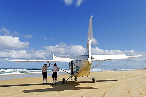 Pilotes and plane on the 75-Mile Beach, Fraser Island, Queensland, Australia