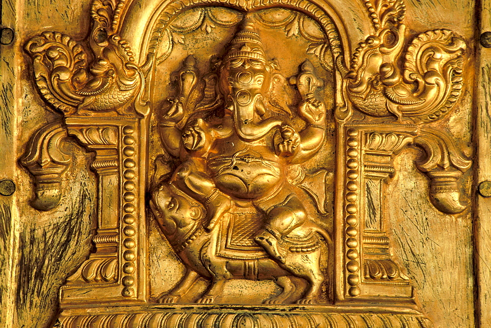 Hindu elephant-headed god Ganesha, Ganesh or Ganpati mounted on a rat, gilded relief, Madurai, Tamil Nadu, South India, India, Asia