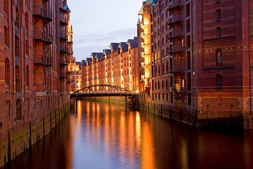 Illuminated warehouses and a channel, Speicherstadt district, Free and Hanseatic City of Hamburg, Germany, Europe