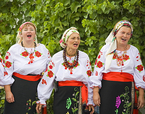 Three peasant women in traditional Ukrainian costume performing a countrified folk dance at the farmers\' museum in the formerly German inhabited Bessarabian village Friedenstal, today\'s Mirnopolje, Ukraine