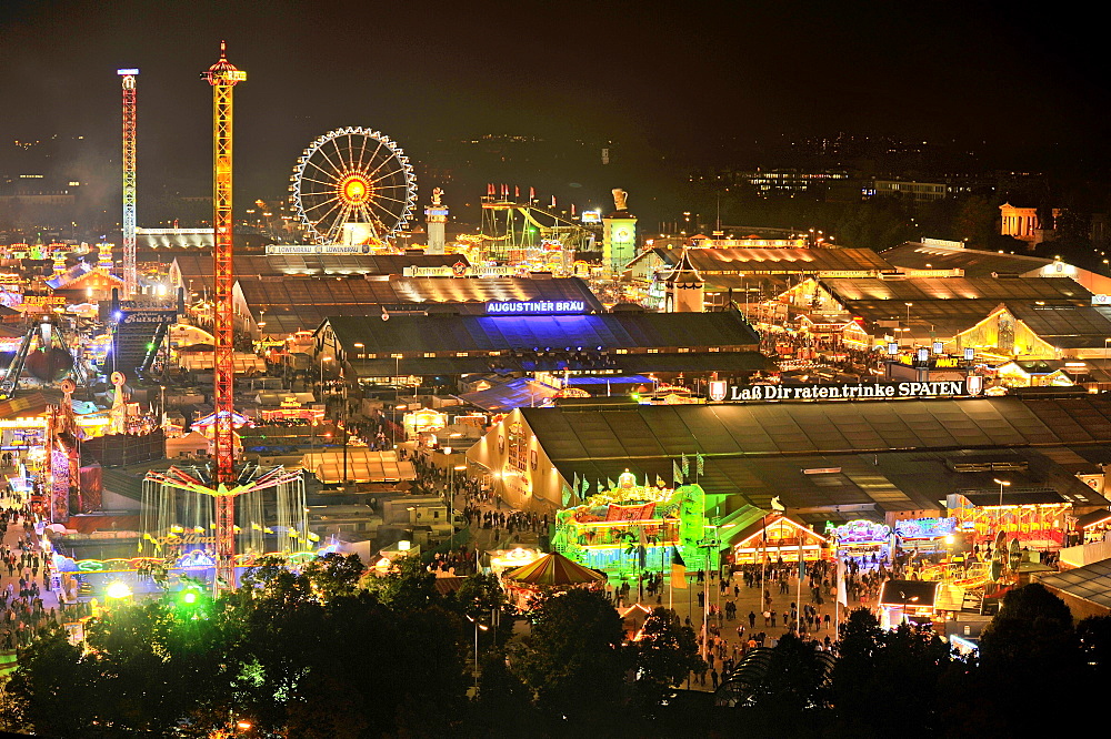 View of the Oktoberfest festival at night, with illuminated stalls, beer tents and funfair rides, Oktoberfest festival, Munich, Upper Bavaria, Bavaria, Germany, Europe