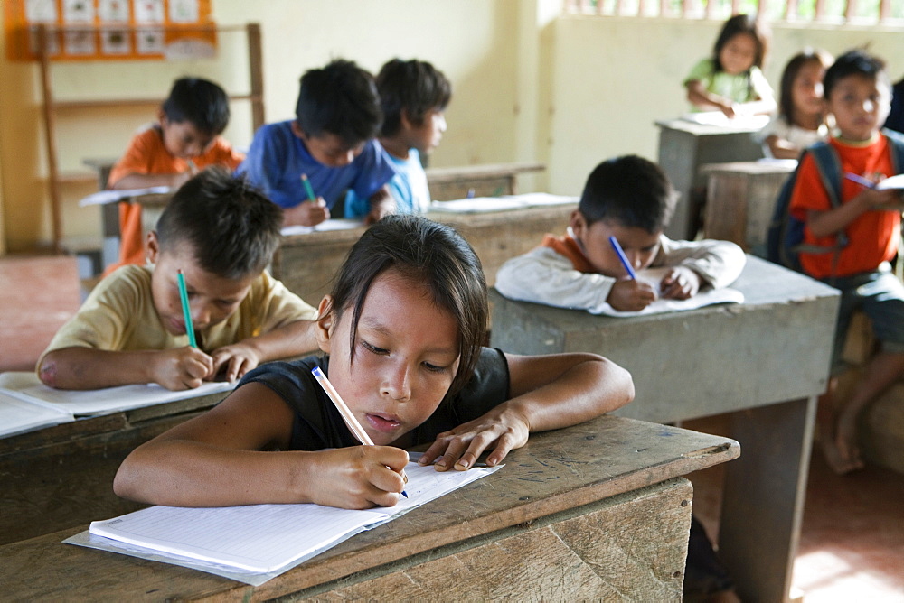 Pupils learning to write in a primary school in a village with no road access in the Oriente rain forest, Curaray, Ecuador, South America