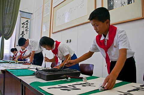 Selected children practicing calligraphy in the Children's Palace, Pyongyang, North Korea, Asia