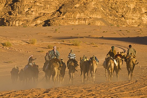 Bedouins with camels in the desert, Wadi Rum, Jordan, Middle East