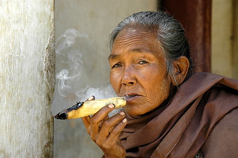 Portrait of a smoker, old woman smoking a hand-rolled cigar, Bagan, Burma, South East-Asia