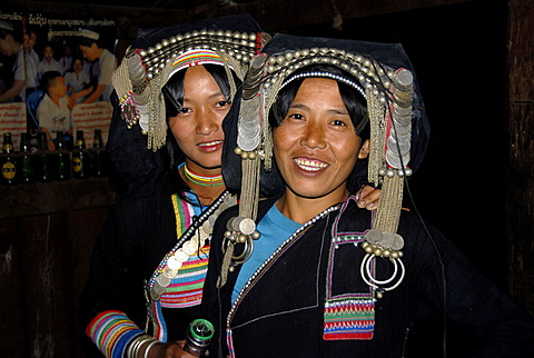 Portrait, ethnology, young Akha Pixor women smiling and wearing silver headdresses and coins, village of Ban Moxoxang, Phongsali, Phongsali district, Laos, Southeast Asia, Asia