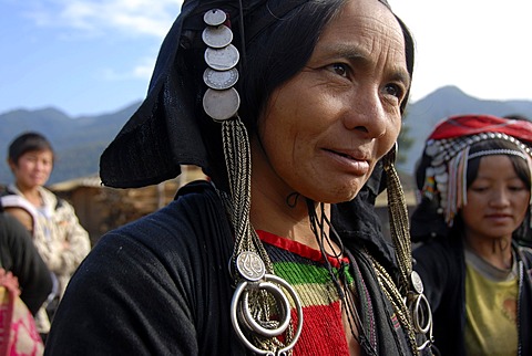 Portrait, smiling woman of the Phixor Akha ethnic group, traditional clothing dyed with indigo, headdress with silver coins, village Ban Bounpiang, Boun Neua district, Phongsali province, Laos, Southeast Asia, Asia