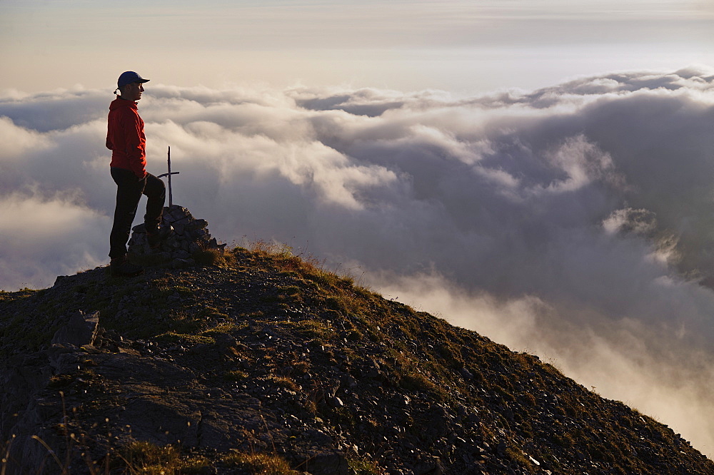 Mountaineer on a summit with fog, Ammergebirge, Ammer Mountains, Garmisch, Bavaria, Germany, Europe