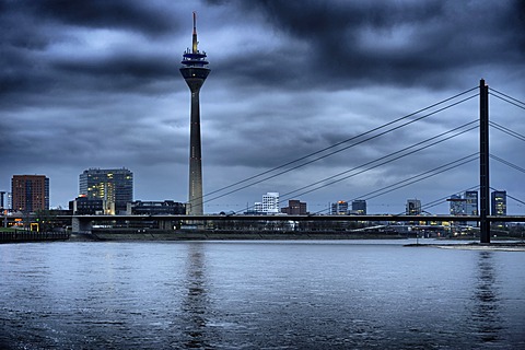 Rheinturm tower with the Rhine and the skyline at dusk, Medienhafen, Media Harbour, Duesseldorf, North Rhine-Westphalia, Germany, Europe