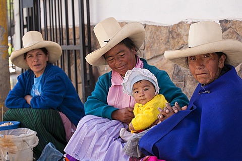 Indigenous street vendors with a child, BaâˆšÂ±os del Inca, Peru, South America