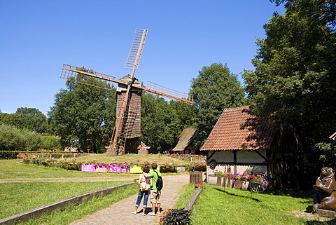 Visitors in front of the Bockwindmuehle windmill at the Muehlenhof Open-Air Museum, Muenster, North Rhine-Westphalia, Germany, Europe