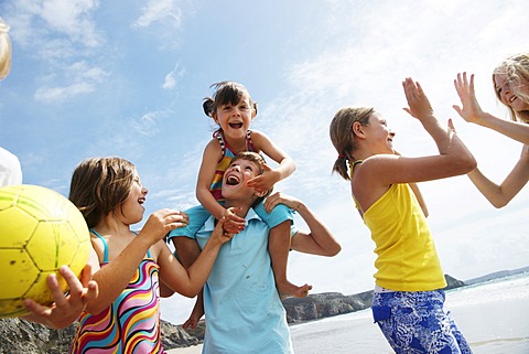 Two boys and four girls having fun on the beach, laughing, Bretagne, France, Europe