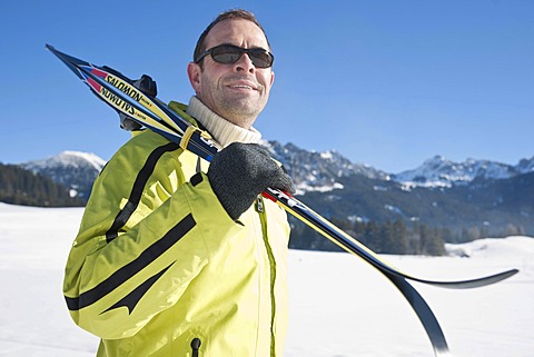 Man with cross-country skis in the mountains