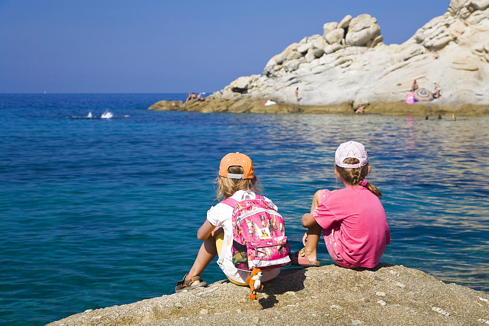 Two girls sitting on a cliff near Sant\'Andrea, Elba, Tuscany, Italy, Mediterranean, Europe