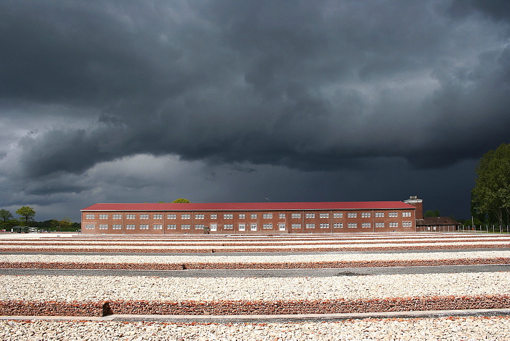 Neuengamme concentration camp memorial site, SS main guard building with guard tower, right, prisoner block 1-4, centre, foundations of the detainee block, emerging thunderstorm, Hamburg, Hamburg, Hamburg, Germany, Europe