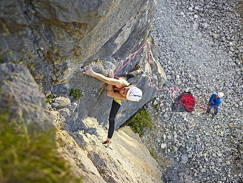 Woman lead climbing a ledge, Martinswand climbing area, Zirl, Tyrol, Austria, Europe