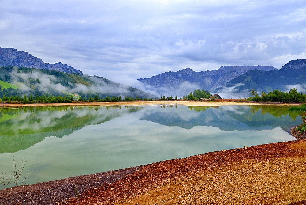 Sedimentation pool, sludge pond in the mining area of ??the open pit mine, Erzberg mountain at Eisenerz, Styria, Austria, Europe