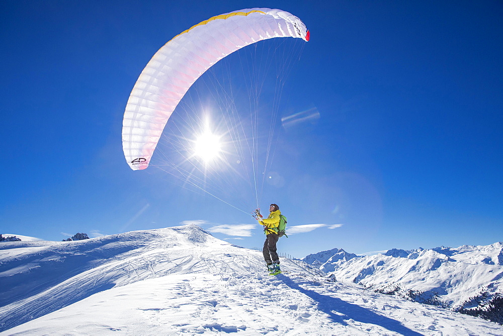 Paraglider, man preparing glider for takeoff, Axamer Lizum, Innsbruck, Tyrol, Austria, Europe