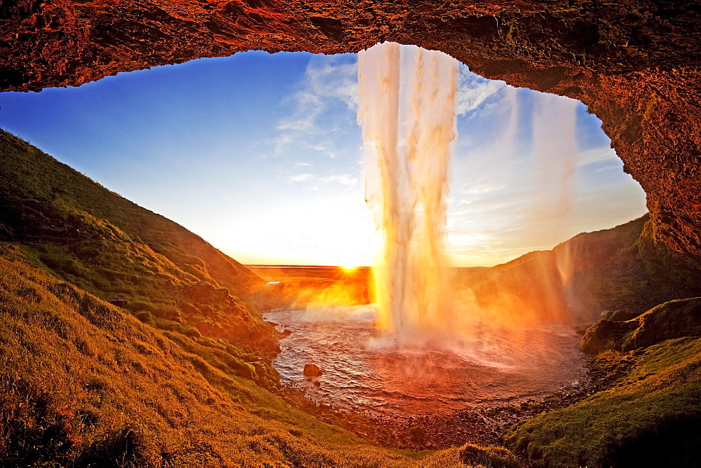 Seljalandsfoss waterfall in the back light, Seljalandsa river, South Island, Island