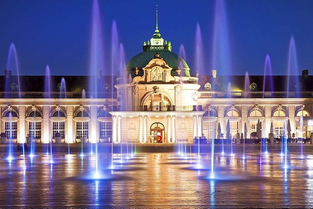 Illuminated imperial palace with water fountains in the blue hour, spa garden, Bad Oeynhausen, Ostwestfalen-Lippe, North Rhine-Westphalia, Germany, Europe