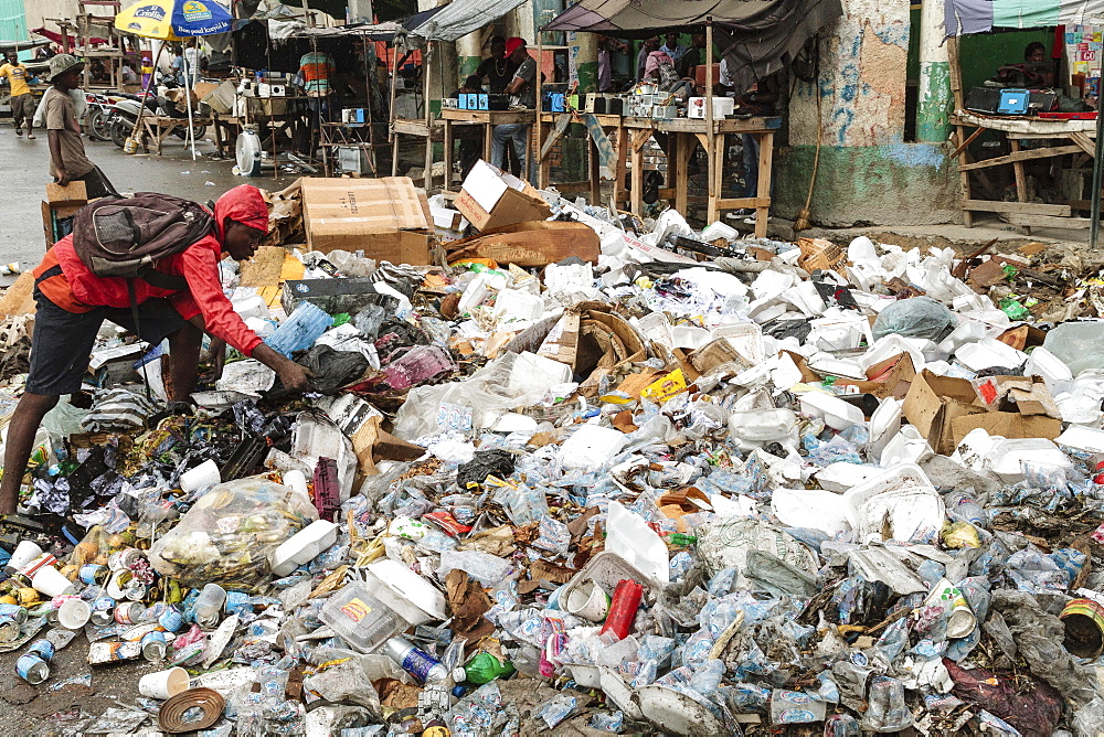 Man rummages in garbage, garbage dump, roadside, Port-au-Prince, Ouest, Haiti, Central America