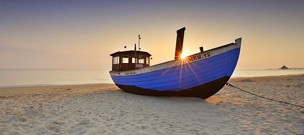 Fishing boat on beach at sunrise, Heringsdorf, Usedom, Mecklenburg-Western Pomerania, Germany, Europe