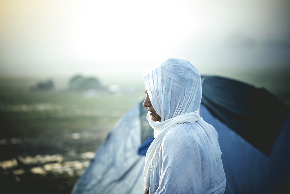 Woman in front of tent, refugee camp Idomeni on the Greek-Macedonian border, Greece, Europe