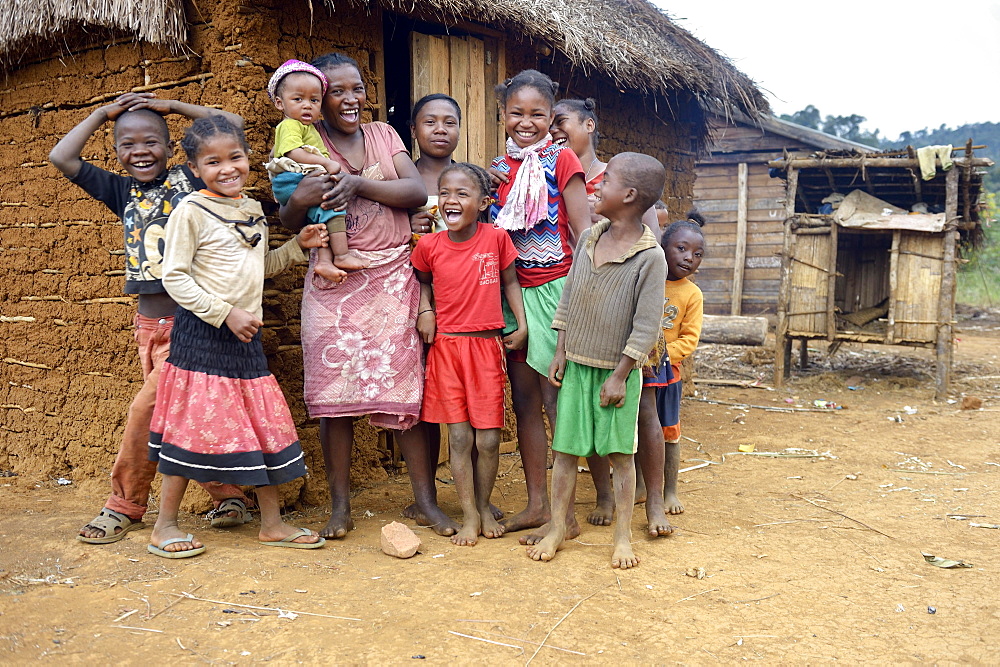 Laughing women and children in front of hut, Berano, Moramanga, Alaotra-Mangoro region, Madagascar, Africa