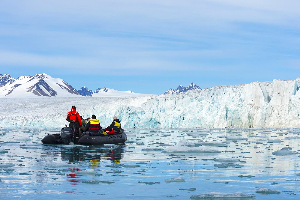 Zodiac boat with tourists navigating in front of Lilliehook glacier, Lilliehook fjord, Spitsbergen Island, Svalbard Archipelago, Norway, Europe