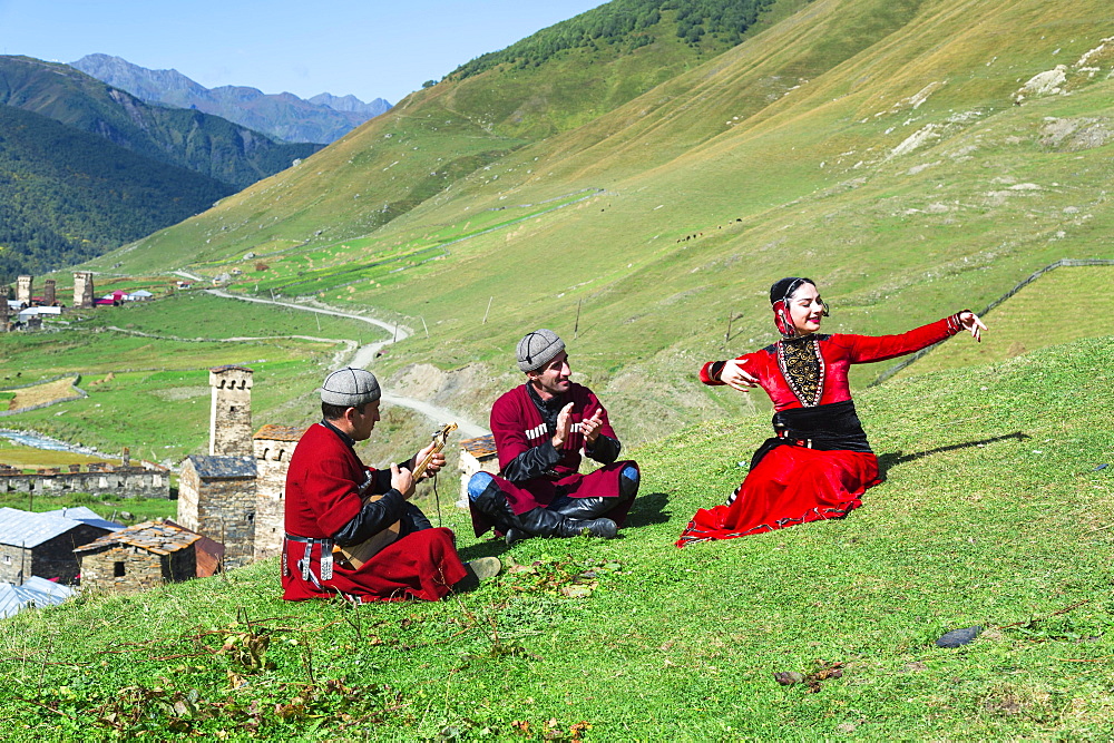 Georgian people of a folkloric group playing Panduri and dancing in traditional Georgian clothes, Ushguli, Svaneti region, Georgia, Asia