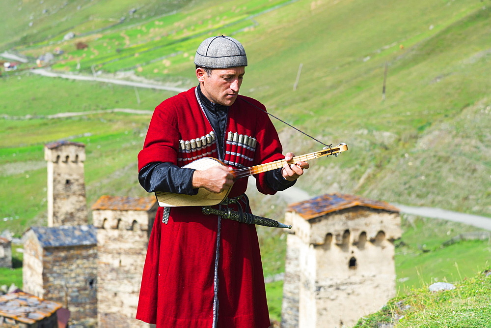 Georgian musician of a folkloric group playing Panduri, Ushguli, Svaneti region, Georgia, Asia