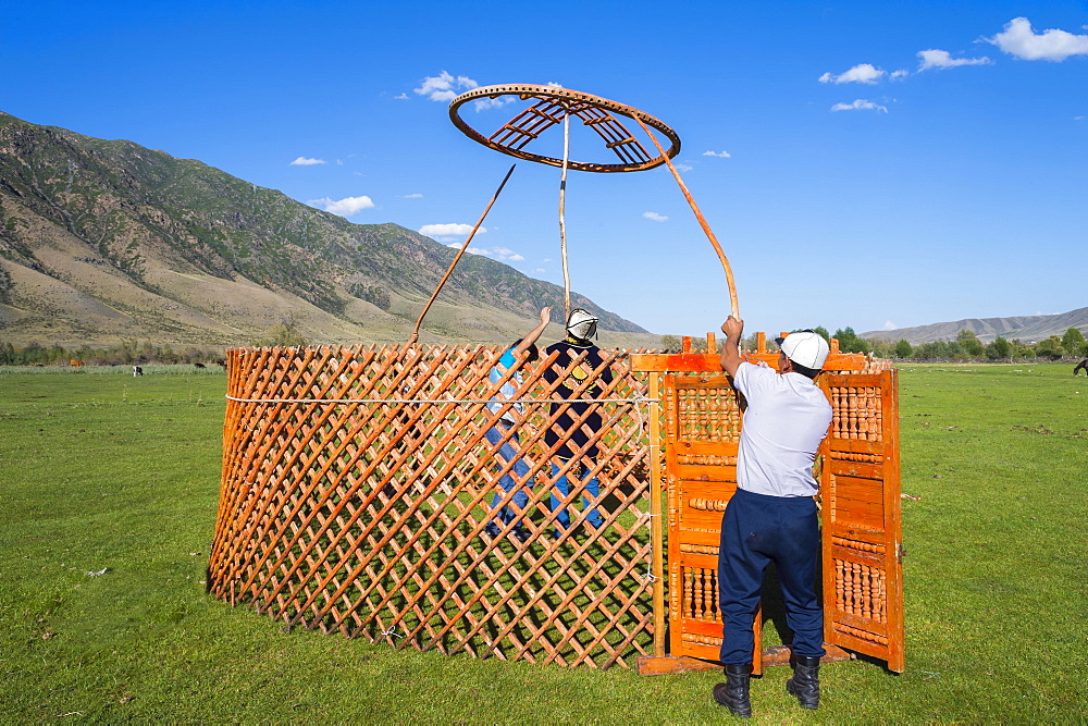 Kazakh men putting up a yurt, Sati village, Tien Shan Mountains, Kazakhstan, Asia