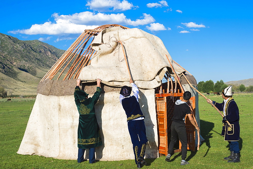 Kazakh men putting up a yurt, Sati village, Tien Shan Mountains, Kazakhstan, Asia