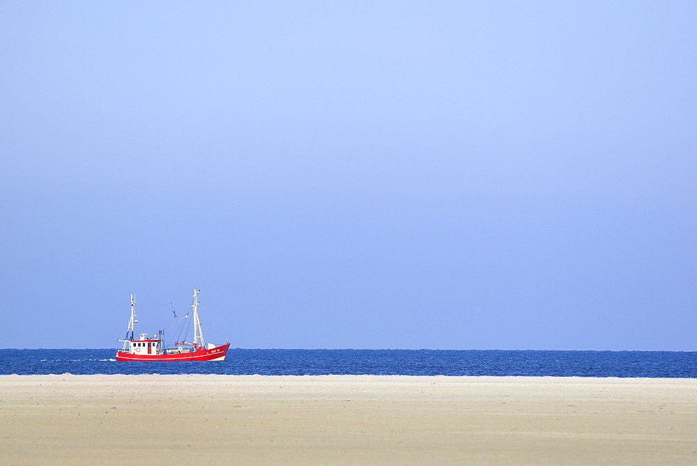 Red fishing boat in the North Sea, St. Peter-Ording Beach, Schleswig-Holstein Wadden Sea National Park, North Frisia, Schleswig-Holstein, Germany, Europe