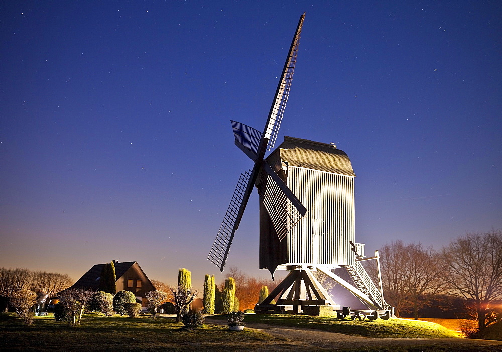 Illuminated Kastenbockwindmühle, historical windmill, with starry sky, Tönisberg, Kempen, Lower Rhine, North Rhine-Westphalia, Germany, Europe