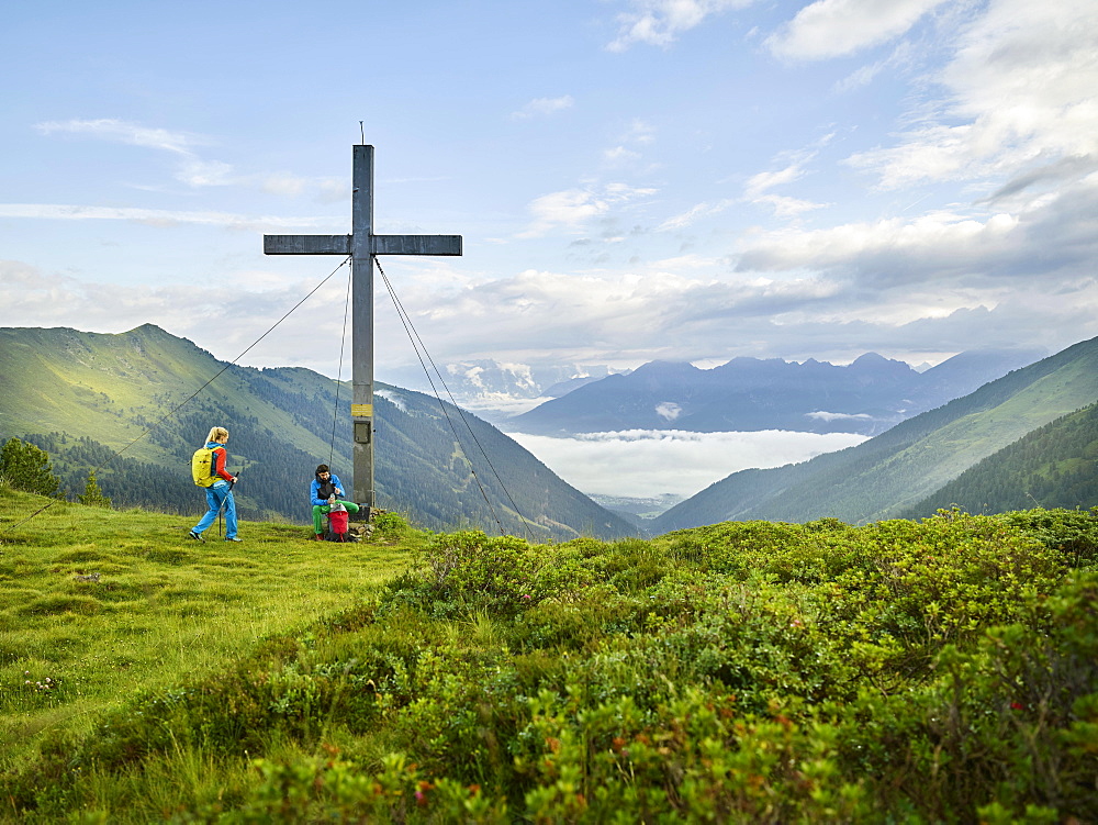 Hikers at summit cross, Kemater Alm, Kalkkögel, Tyrol, Austria, Europe