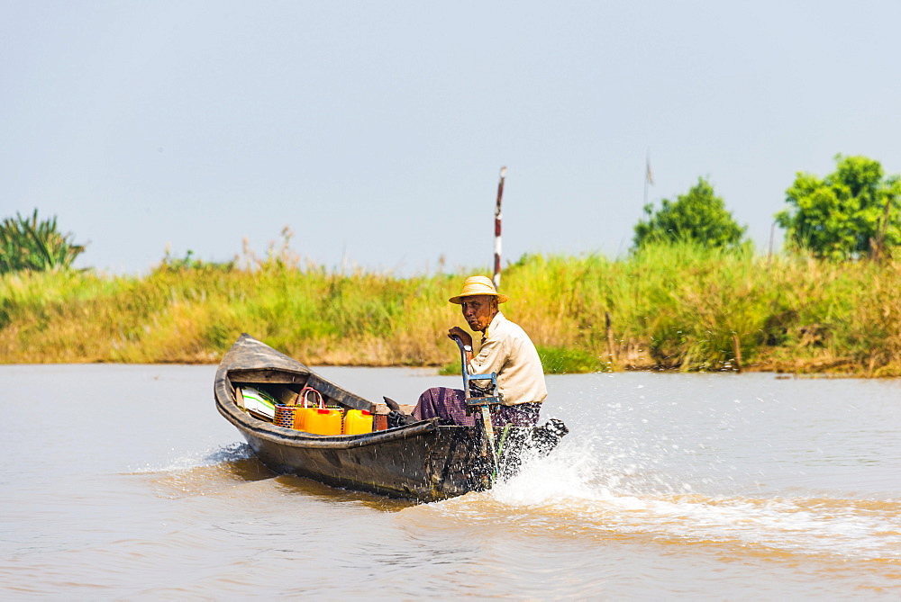 Local man steers motorboat, Inle Lake, Shan State, Myanmar, Asia