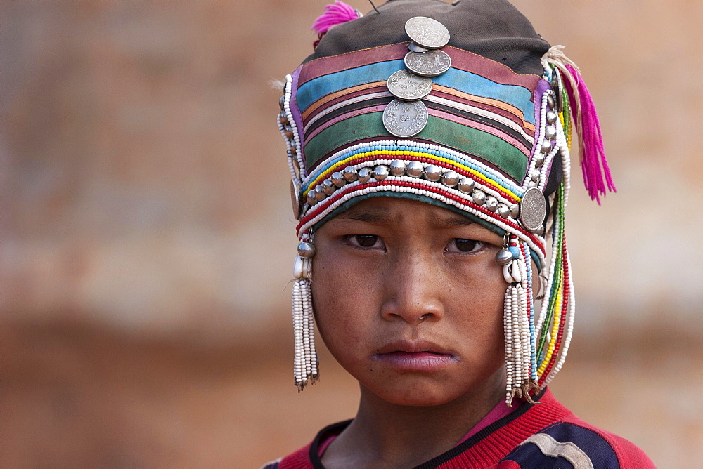 Girl of the Akha ethnic group with traditional headdress, portrait, near Kyaing Tong, Myanmar, Asia